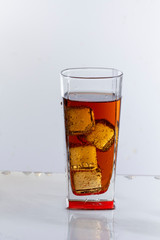 Cold refreshing soft drink with ice on a white background