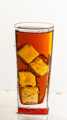 Cold refreshing soft drink with ice on a white background