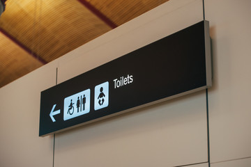 Toilet sign direction at airport