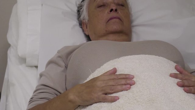 4k footage of acupuncturist inserting needles to a pacient during an acupuncture treatment in a private clinic