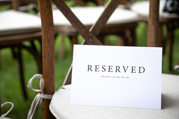Reserved Mother of the Bride sign on a chair, with space for text