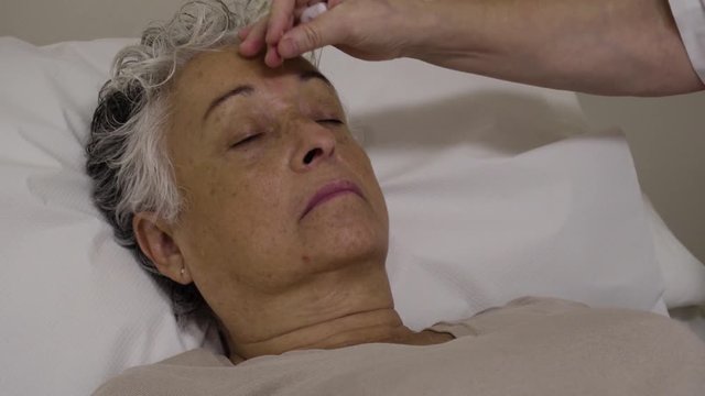4k footage of acupuncturist inserting needles to a pacient during an acupuncture treatment in a private clinic