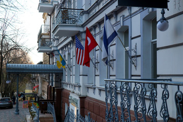 The building of an international club in the city of Odessa with foreign flags on the facade.