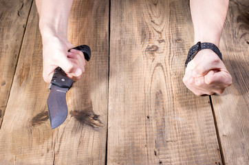 Robber with a knife in his hands. A man with a knife.
