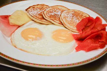 eggs, pancakes, salmon and fruit breakfast