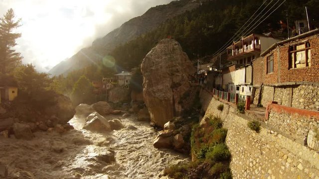 Gangotri first mountain town on river Ganges with brown water Himalya with forest on mountainsides