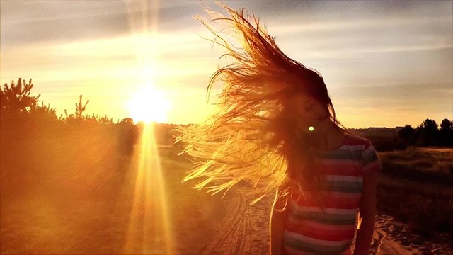 Litttle girl wawing her long hair at sunset, slow motion in retro style