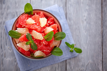 grapefruit plate on wooden background. Citrus diet