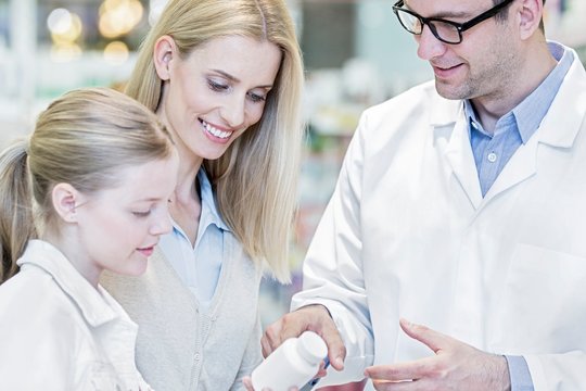 Pharmacist and customers in pharmacy