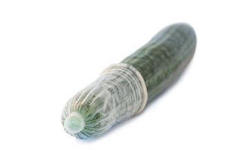 Transparent condom on a cucumber, isolated on a white background. Concept photo of contraception,...