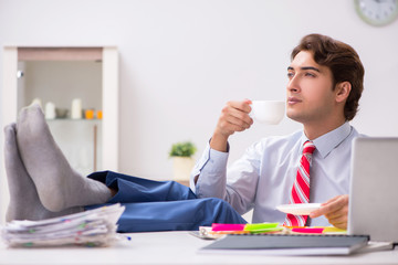 Young attractive businessman working in the office  