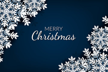 Christmas greeting card with paper snowflakes on blue background.