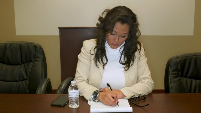 Female Hispanic Lawyer Listening to Evidence at a Deposition