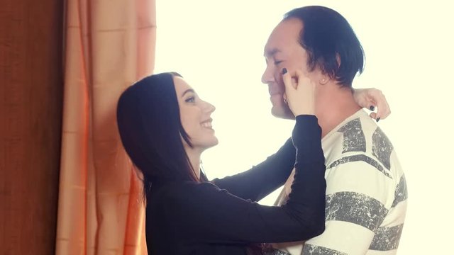 A love story between an Asian man and a European woman, an Asian guy with long black hair, a European with long black hair, a slim girl, plump guy, family life, home comfort, weekdays of young couple