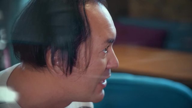 A love story between an Asian man and a European woman, an Asian guy with long black hair, a European with long black hair, a slim girl, plump guy, family life, home comfort, weekdays of young couple