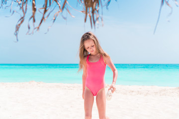 Portrait of adorable little girl at beach on her summer vacation