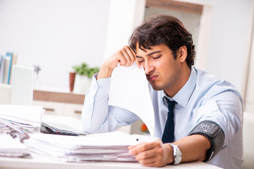 Man under stress measuring his blood pressure