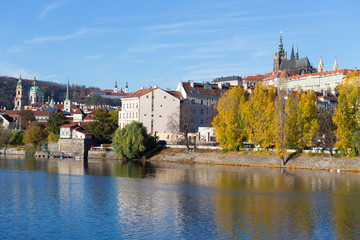 Fototapeta premium Colorful autumn Prague gothic Castle with the Lesser Town above River Vltava in the sunny Day, Czech Republic