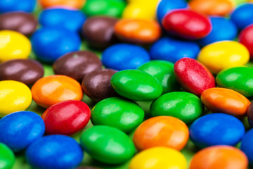 Fototapeta na wymiar Background of glazed bright colorful chocolate candies