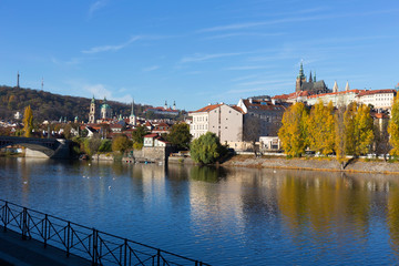 Colorful autumn Prague gothic Castle with the Lesser Town above River Vltava in the sunny Day, Czech Republic