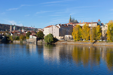 Colorful autumn Prague gothic Castle with the Lesser Town above River Vltava in the sunny Day, Czech Republic