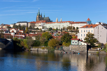 Fototapeta na wymiar Colorful autumn Prague gothic Castle with the Lesser Town above River Vltava in the sunny Day, Czech Republic