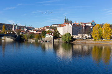 Obraz na płótnie Canvas Colorful autumn Prague gothic Castle with the Lesser Town above River Vltava in the sunny Day, Czech Republic
