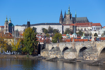 Colorful autumn Prague gothic Castle and Charles Bridge with the Lesser Town in the sunny Day, Czech Republic