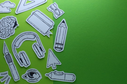 Creative Work Graphic Designer  Related Tools Symbols Devices Objects Top View Conceptual Composition With Hand Drawn Inked Paper Cutted Art On Green Background