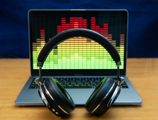 studio headphones in front of laptop with player