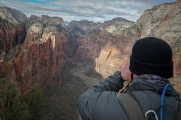 Fototapeta premium Man photograhper hiking Angels Landing in Zion National Park in Southern Utah.