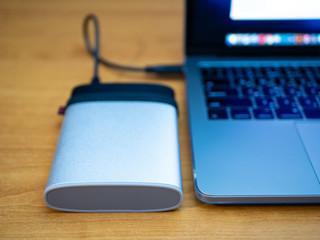 portable ssd disk drive connected to laptop computer