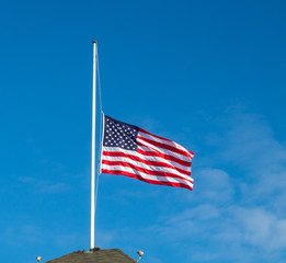 American flag flying at half staff
