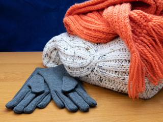 Fototapeta na wymiar winter seasonal apparel set - sweater, gloves and scarf