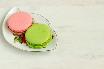 Fresh macaroons on plate.