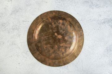 back side of vintage brass plate