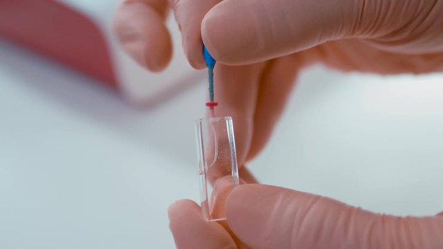 Dentist is Doing Obturation Procedure while Training Cleaning and Shaping Dental Root Canals on Glass Sample in Laboratory