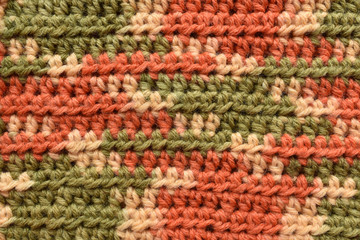 Fototapeta na wymiar a seamless crocheted texture orange,green and beige,