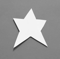 shape of star with torn paper on gray background with copy space for text