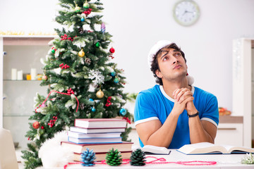 Young student with book at Christmas eve 