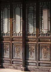 Traditional wooden chinese style entrance door with bamboo image in an old town in China, Asia