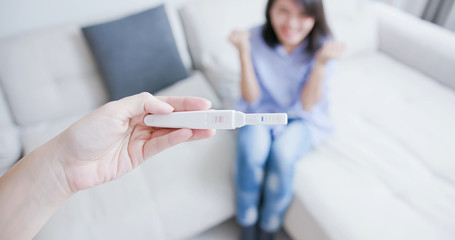 woman show pregnancy test stick