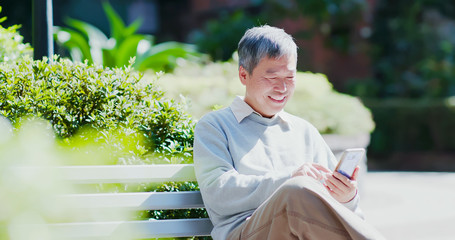 old man use smart phone