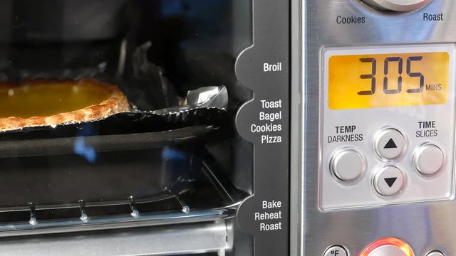 Motion of egg tart baking and time counting down inside toaster oven at kitchen with 4k resolution