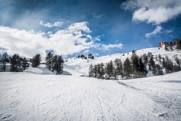 Fototapeta na wymiar Beautiful ski slope at La Plagne in the French Alps, view from drone