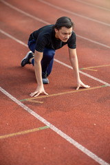 Asian couple at track stadium exercising for healthy lifestyle