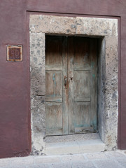 Rustic wooden doors on colorful buildings in San Miguel de Allende, Mexico