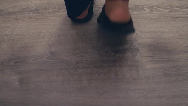 Close uo of child girl feet wearing cosy slippers at home, 4k