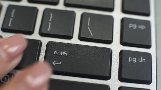 View to laptop keyboard, woman pressing enter button, easy access, data entry