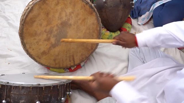 Man playing on a drum on time Pushkar Camel Mela near holy city Pushkar, Rajasthan, India, close up. Drums hands, movement, rhythm